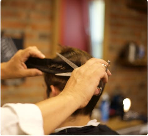 Barbour cuts man's hair
