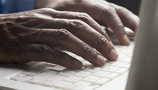 Hands typing on a keyboard