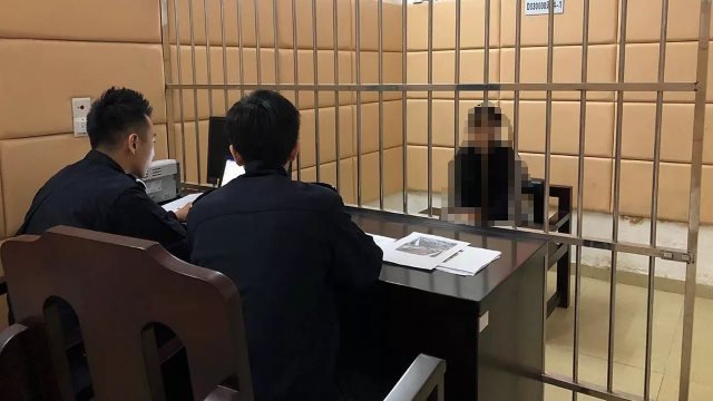 Police officers questioning a detainee