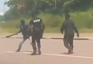 a man with a machete approaching a police officer on the street