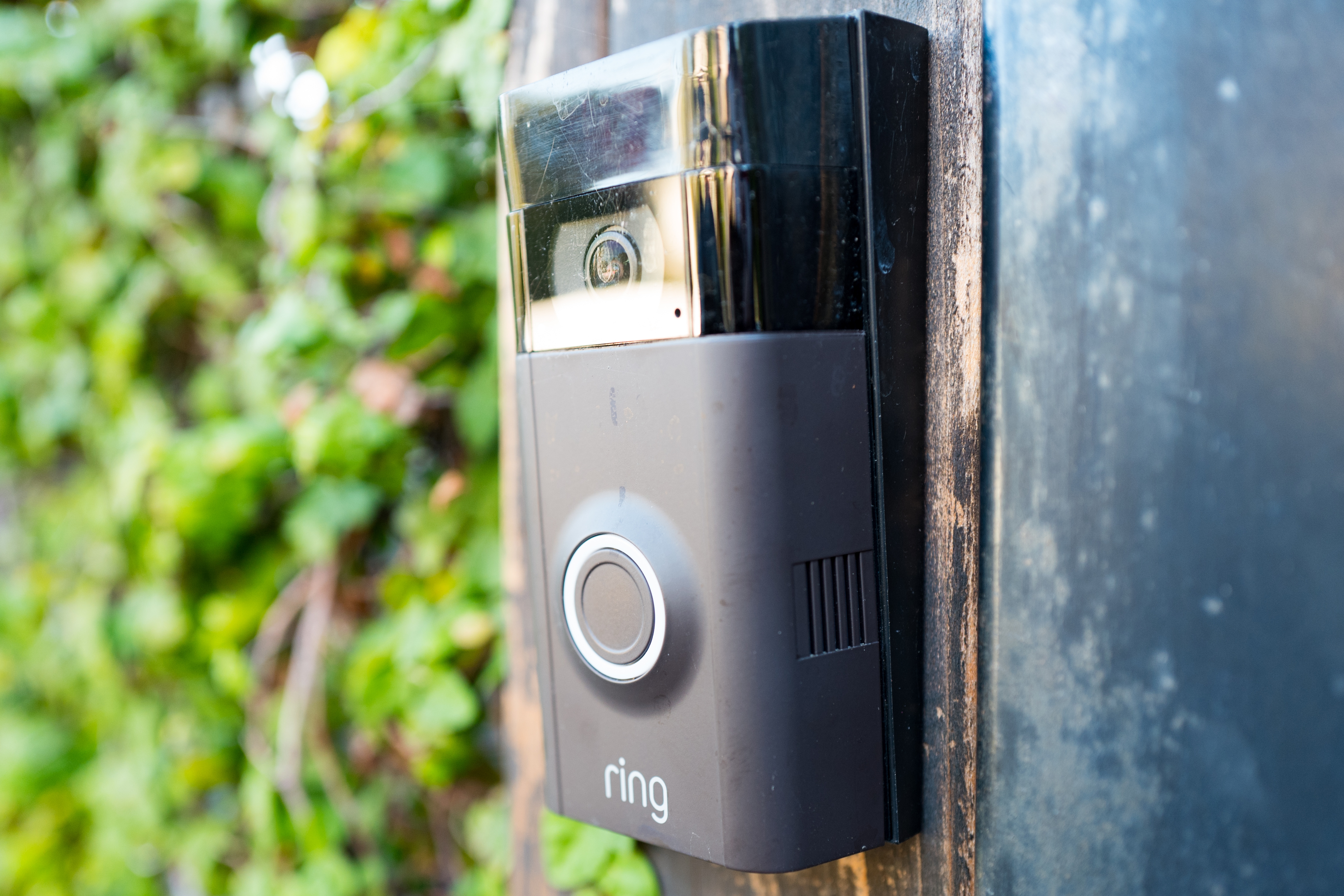 A Ring doorbell on the wall of a house&rsquo;s front porch.