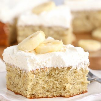 Slice of banana cake on a white plate.