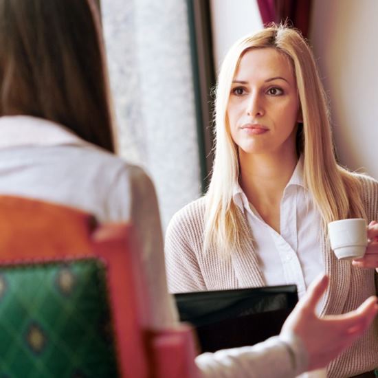 Two women talking over coffee