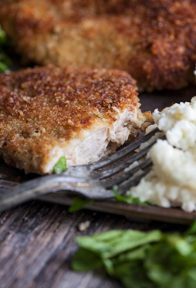 a sliced parmesan turkey cutlet on a plate