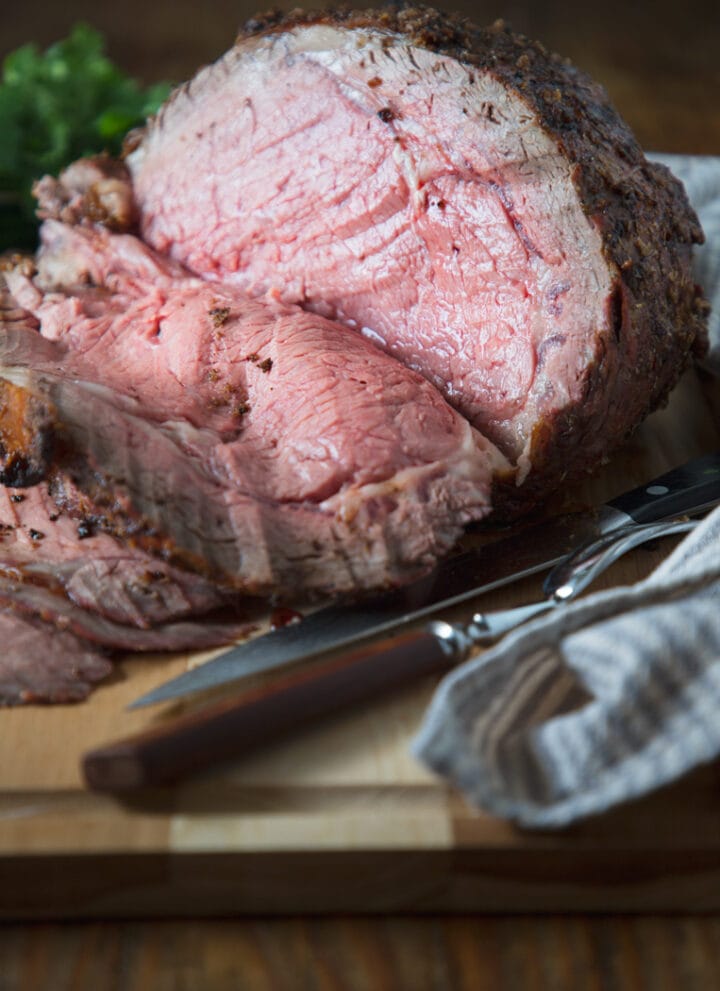 a big prime rib sliced on a cutting board