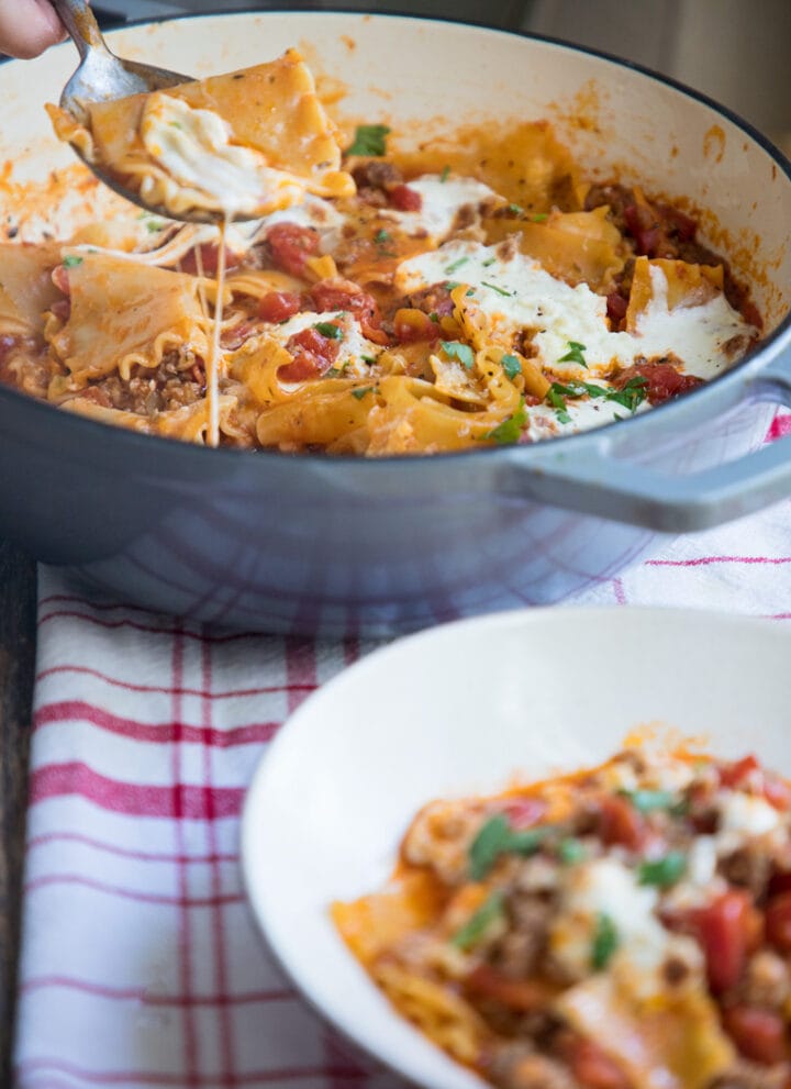 a big pan of skillet lasagna being served into a bowl