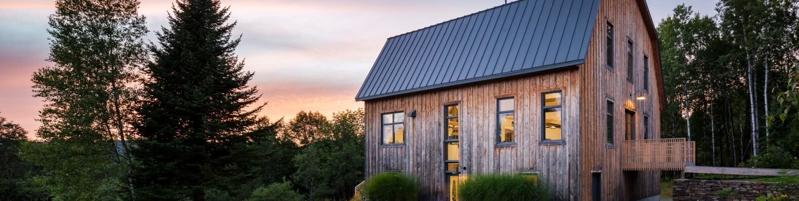 large barn home on green hill