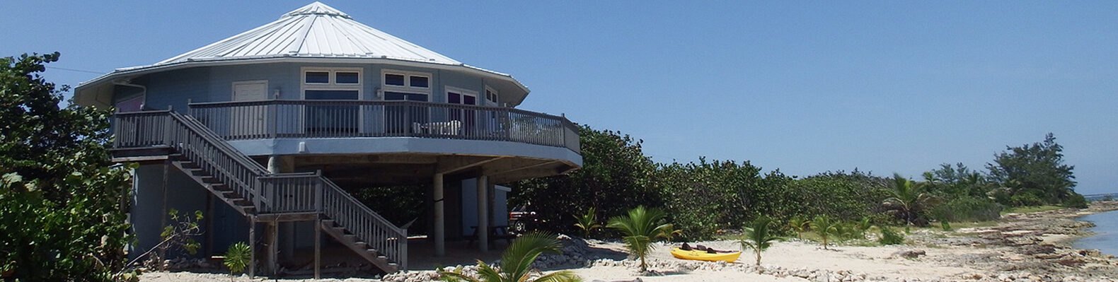 light blue round home on a beach
