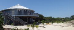light blue round home on a beach