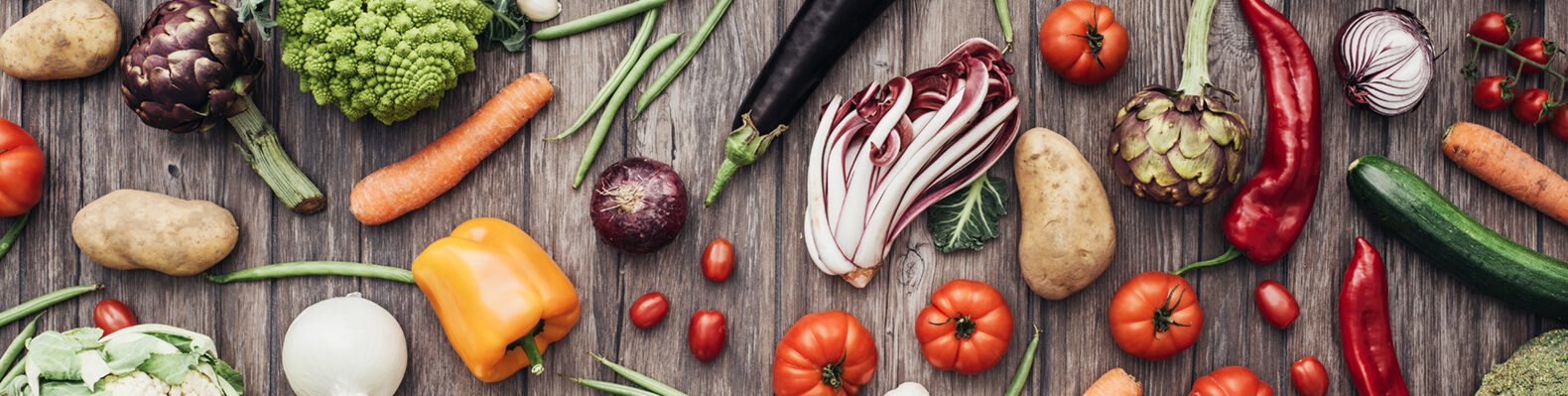 fruits and vegetables on a wood background