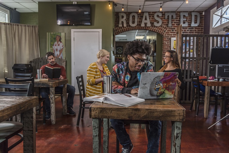 african american male working on laptop in coffee shop