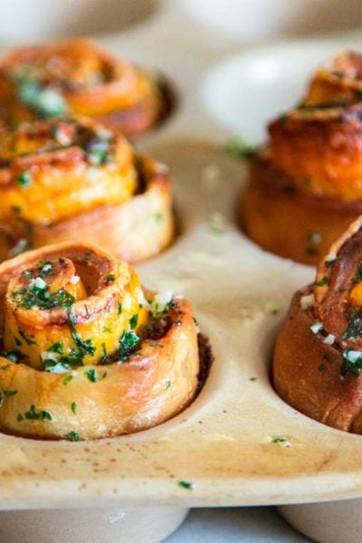 My baked Roast Beef Cheddar Muffins start with pizza dough smothered in dijon horseradish cream, layered with slices of tender roast beef and cheddar cheese. Perfect snack food! keviniscooking.com