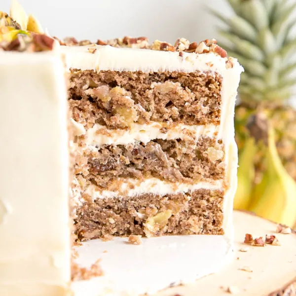 This classic Hummingbird Cake is packed with pineapple, banana, and pecans. Ultra moist cake layers with hints of cinnamon and nutmeg covered in a cream cheese frosting. | livforcake.com
