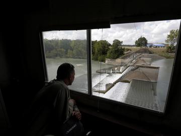 Guadalupe-Blanco River Authority's John Moryl looks over the spill gates at Lake Dunlap, Oct. 2, 2019, in Lake Dunlap, Texas. One of the spill gates at the dam failed in May.