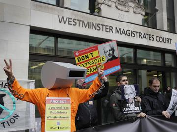 Supporters of Wikileaks founder Julian Assange demonstrate outside Westminster Magistrates' Court in London.