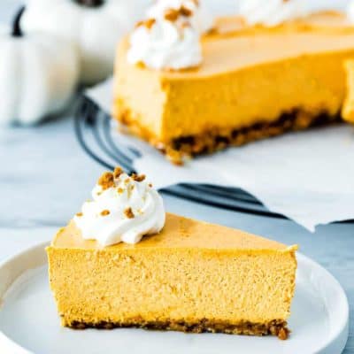 slice of eggless pumpkin cheesecake in a white plate
