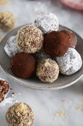 rum balls with different coverings on a marble surface