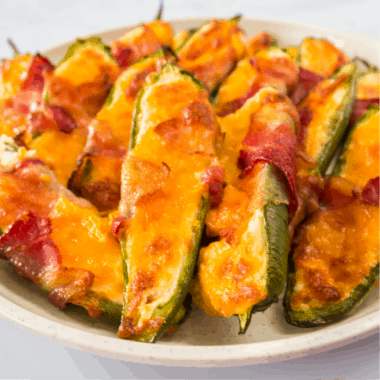 Bacon Wrapped Jalapeno Poppers are the party app you need to make. Loaded with a cheesy cream cheese mixture and baked to perfection, no one can resist!