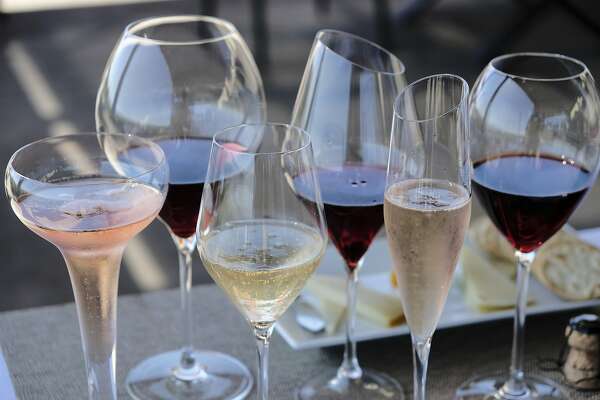 FILE - This Monday, July 10, 2017 file photo shows different shaped glasses of wine in Sonoma, Calif. According to a large genetic study released on Thursday, April 4, 2019, drinking alcohol raises the risk of high blood pressure and stroke, debunking previous claims that moderate drinking was protective. (AP Photo/Eric Risberg)
