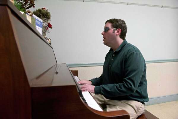 Brian Horberg, 30, of Danbury, is a blind and half-deaf pianist who plays at local senior centers, nursing homes and schools. Horberg is entertains the lunch crowd at the New Milford Senior Center, Monday, December 16, 2019, in New Milford, Conn.