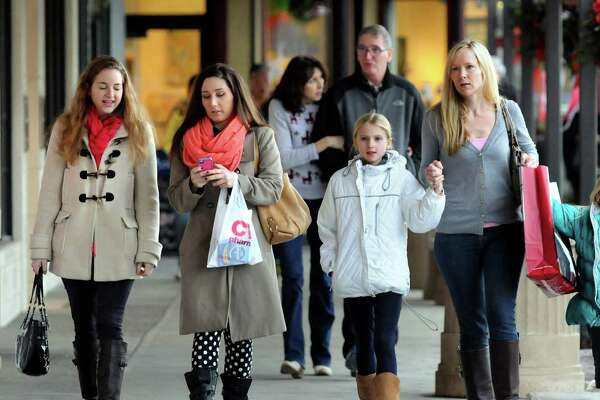 Shoppers walk with their purchases on Saturday, Dec. 21, 2013, at Stuyvesant Plaza in Albany, N.Y (Cindy Schultz / Times Union)
