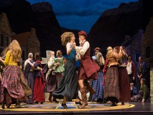 Man and woman dancing in Scottish garb