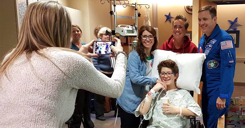 Young patient taking a photo opportunity with an astronaut