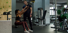 Female exercising with trx fitness straps at gym