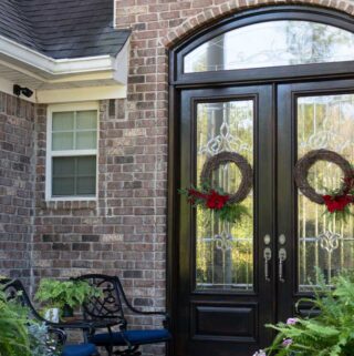 front double doors with lorex security camera mounted on wall nearby