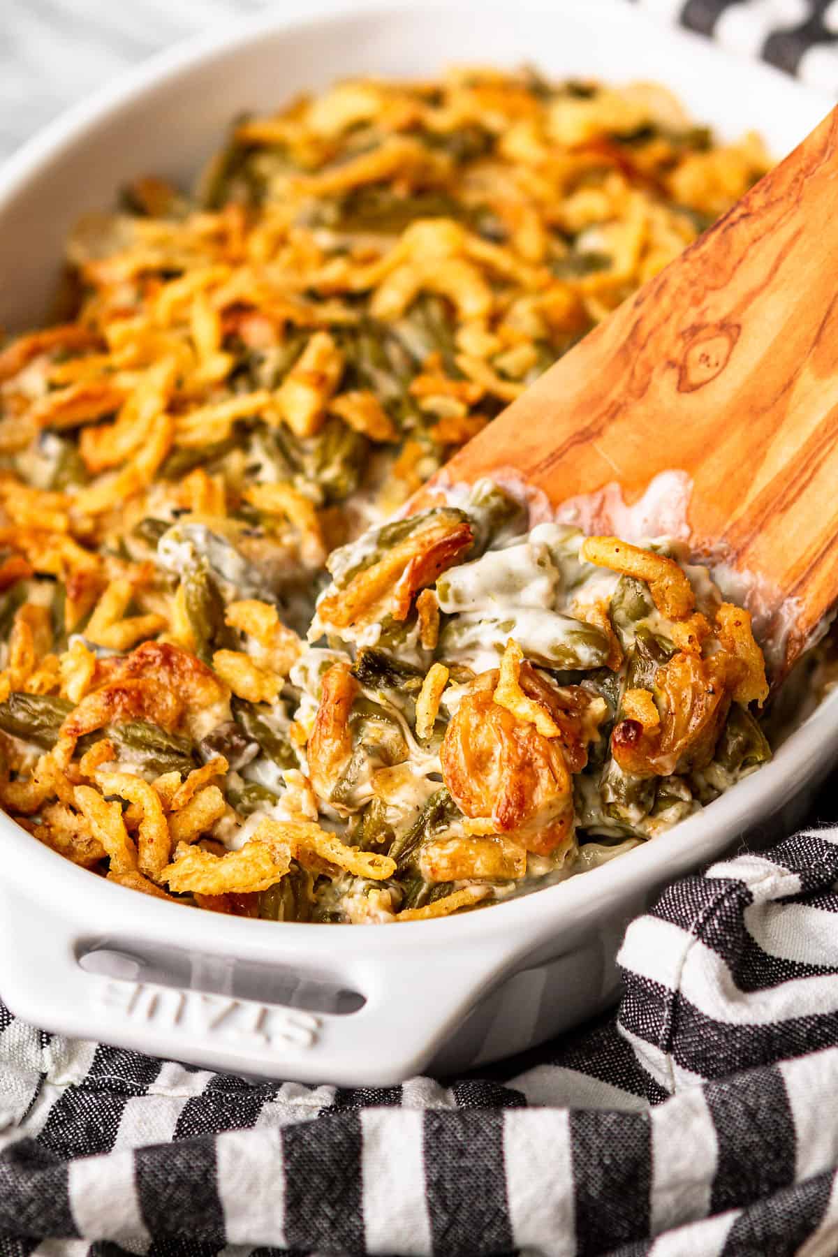 easy green bean casserole with a wooden spatula