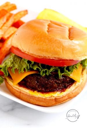 Air fryer burger with cheese, lettuce and tomato