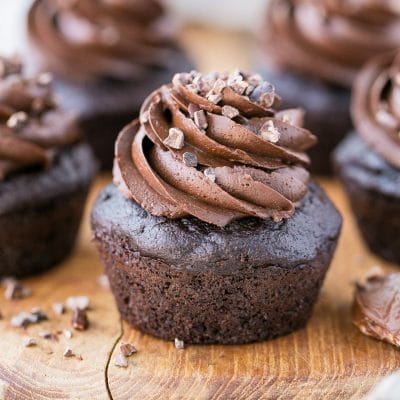 These Paleo Chocolate Zucchini Cupcakes are topped with a rich and fudgy Paleo Chocolate Frosting! You'd never guess there are veggies packed into these super moist and chocolatey cupcakes.