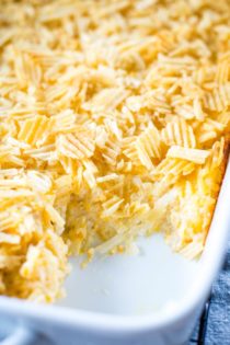 slice out of cheesy hashbrown casserole in pan