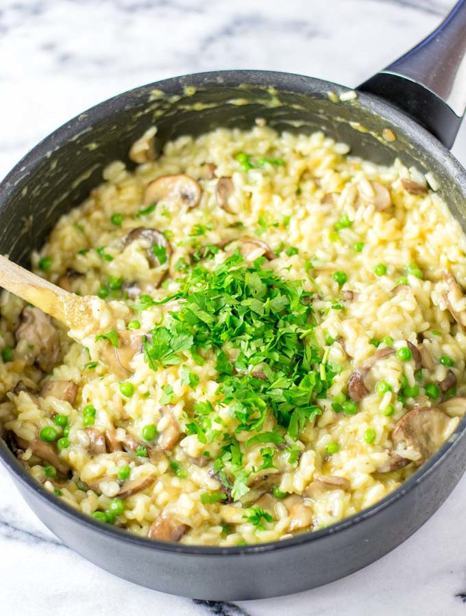 Large saucepan with the Mushroom Risotto, garnished with fresh parsley.