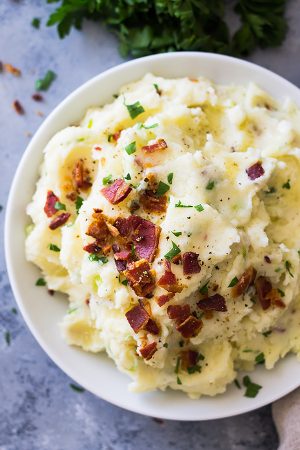 Bacon Mashed Potatoes are creamy, fluffy and full of flavor! Studded with crispy bacon, green onions and made ultra decadent with a little cream cheese. | www.countrysidecravings.com