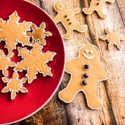 Gingerbread cookies decorated as snowflakes and gingerbread men on a red plate