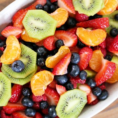 This fruit salad with honey lime dressing is the only recipe you need for all of your summer celebrations! It is my go-to recipe when I need to bring something to a BBQ or picnic. Fresh, colorful berries paired perfectly with a honey lime glaze you will want to eat with a spoon.
