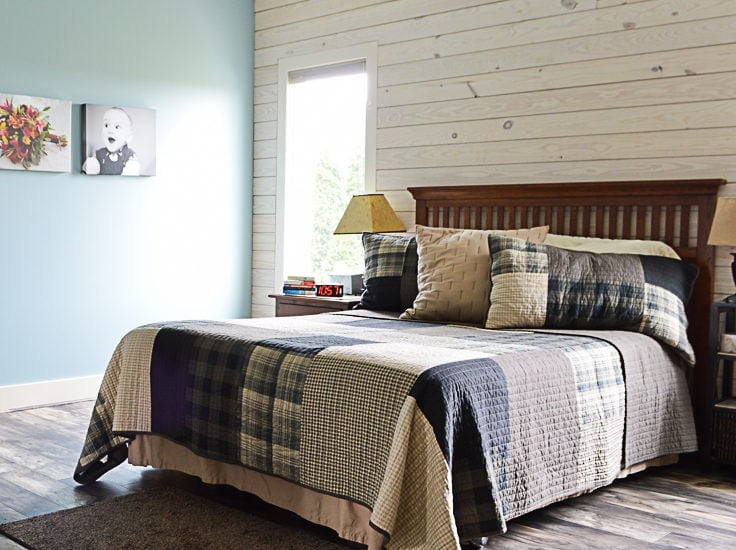 Queen sized bed with a Woolrich quilt in a master bedroom