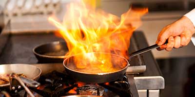 Hot fire in pan on professional gas range
