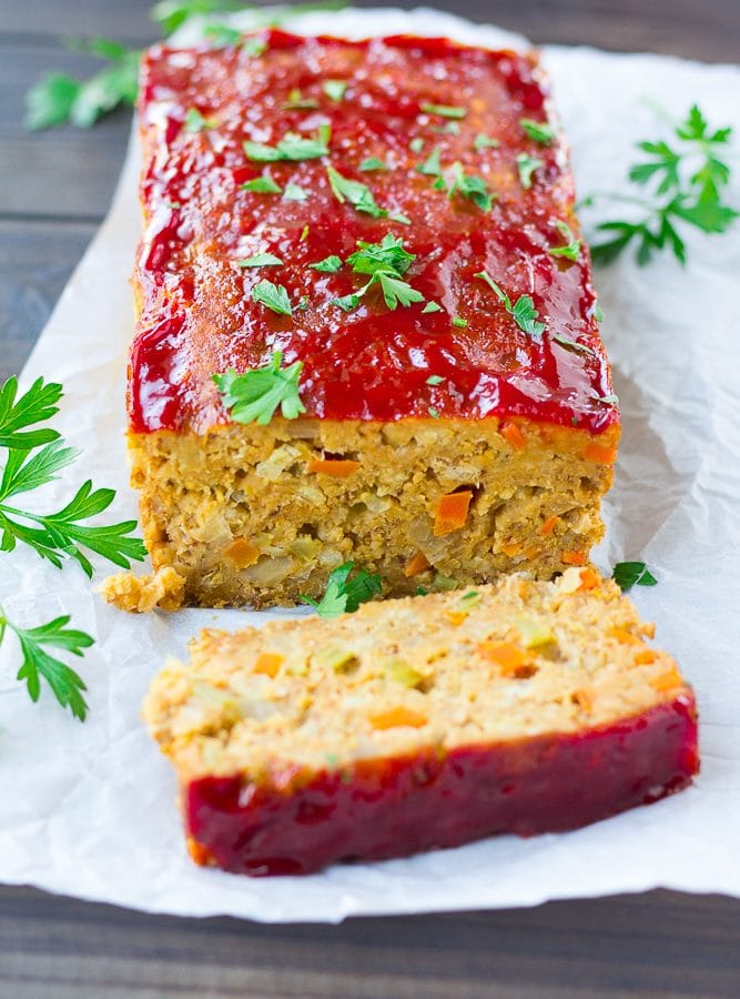 vegan meatloaf on a wooden board with parsley