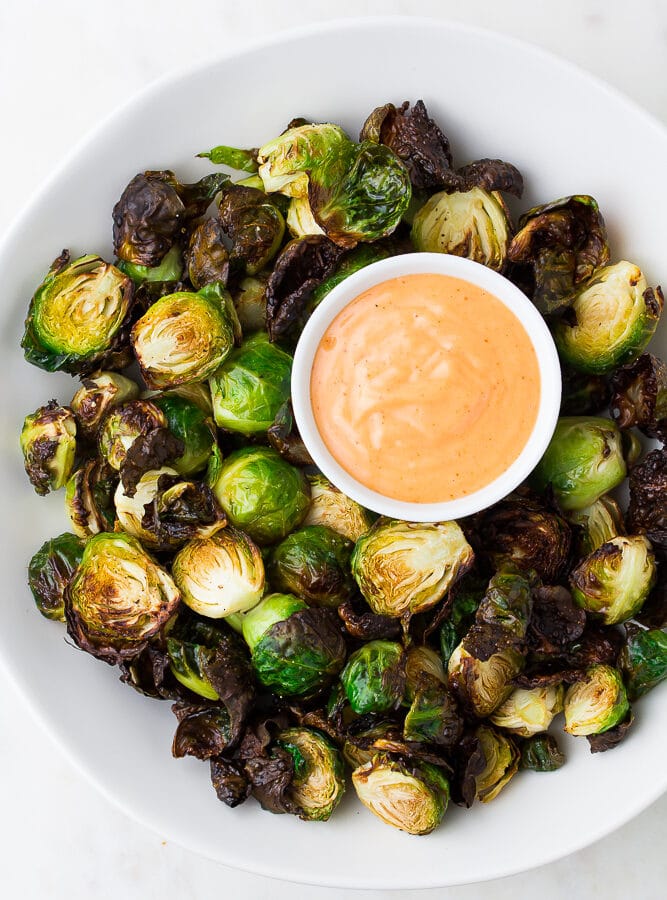 brussels sprouts on a plate with pink sauce