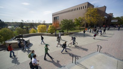 Students walking across campus on a sunny day