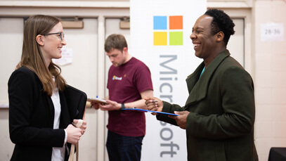R I T student talking to a potential employer at a career fair