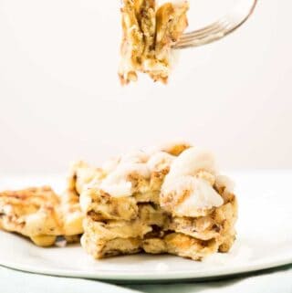 fork with bite of cinnamon bun waffles