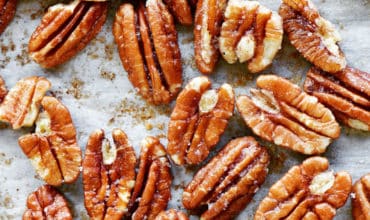 toasted pecans on parchment paper