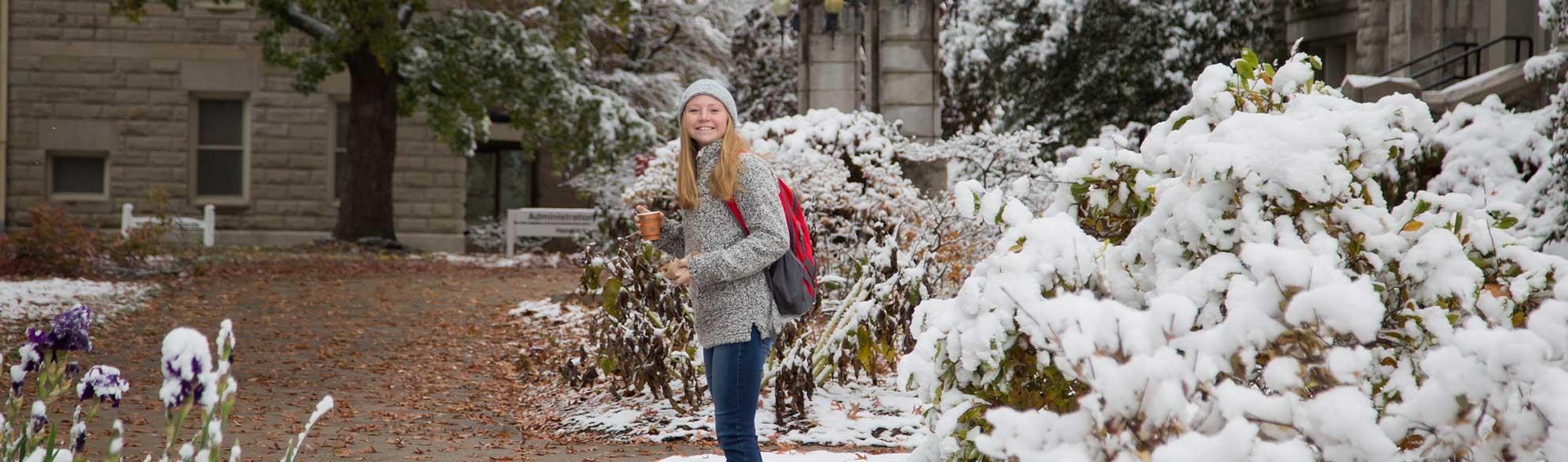 UCM student standing outside with snow.