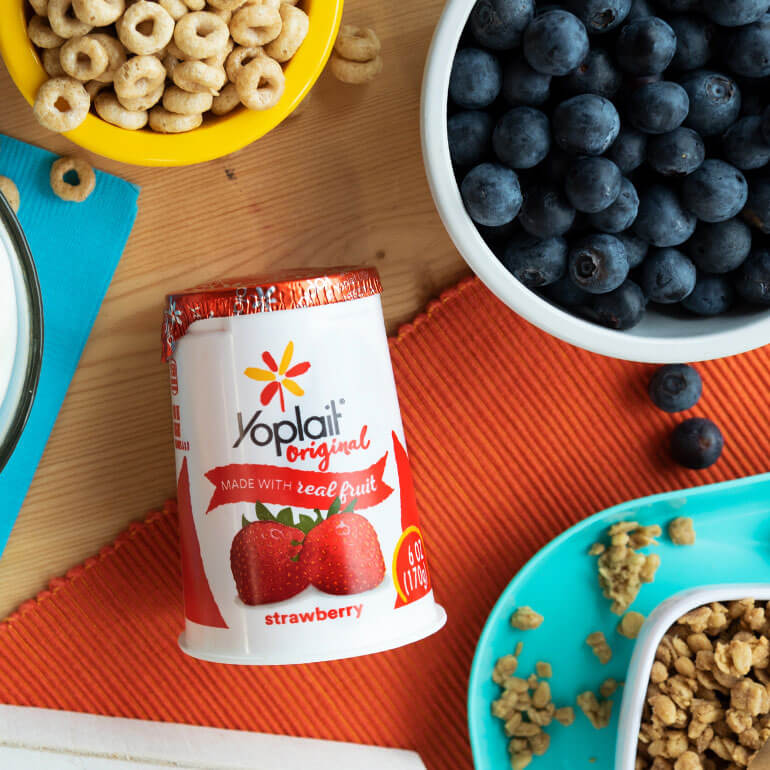 Yoplait strawberry yogurt on table with breakfast food